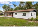A charming single-story home with white paint, brown roofing, and a convenient open carport at 4116 Sw 20Th St, Ocala, FL 34474