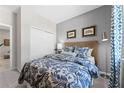 Cozy bedroom features a full bed, a wicker headboard, and blue-patterned bedding for a comfortable retreat at 427 Shoreview Sands Ave, Mascotte, FL 34753
