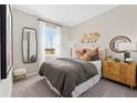 Neutral bedroom showcasing a full bed, decorative accents, and natural light from the window at 427 Shoreview Sands Ave, Mascotte, FL 34753