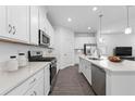 Bright, modern kitchen with white cabinets, stainless steel appliances, and a stylish island at 494 Belmond Dr, Debary, FL 32713