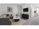 Cozy living room featuring neutral decor, comfortable seating, and a sleek entertainment center at 494 Belmond Dr, Debary, FL 32713
