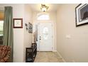 Bright foyer with tile flooring, decorative lighting, and a bench with shoe storage for convenience at 4954 Alavista Dr, Orlando, FL 32837