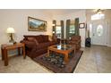 Cozy living room featuring neutral walls, a comfortable sofa, area rug and natural light at 4954 Alavista Dr, Orlando, FL 32837
