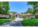 Charming home with lush landscaping and a permeable paver driveway at 5199 Latrobe Dr, Windermere, FL 34786