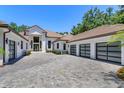 Beautiful home's exterior highlighting the permeable paver driveway and three-car garage at 5199 Latrobe Dr, Windermere, FL 34786