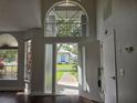 Bright foyer featuring high ceilings, dark floors, and a view of the front yard at 651 Oak Hollow Way, Altamonte Springs, FL 32714
