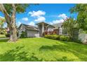 Attractive house with a well-kept lawn and colorful landscaping providing a welcoming and vibrant appearance at 651 Oak Hollow Way, Altamonte Springs, FL 32714