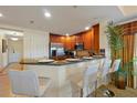 Eat-in kitchen featuring granite countertops, stainless appliances, and barstool seating at 7616 Cabana Ct # 301, Reunion, FL 34747