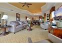 Open-concept living room with a modern sofa, elegant decor, and seamless flow to the dining area and kitchen at 7616 Cabana Ct # 301, Reunion, FL 34747