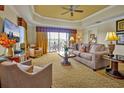 Comfortable living room with plush seating, natural light, and access to outdoor balcony at 7616 Cabana Ct # 301, Reunion, FL 34747