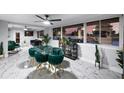 Elegant dining room with marble floors and views of the backyard pool at 8120 Gondola Dr, Orlando, FL 32809