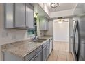 Kitchen featuring ample counter space, stainless steel appliances, and modern gray cabinetry at 856 Mendoza Dr, Kissimmee, FL 34758