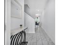 Bright hallway with marble tile flooring leading to a dining area with decor at 8961 Cabot Cliffs Dr, Davenport, FL 33896