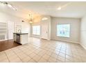 Bright, open-plan living area featuring tile floors and neutral walls at 1001 Golfside Ct, Kissimmee, FL 34741
