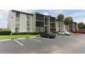 Condo exterior showing well-maintained landscaping, a parking lot, and direct access to units at 1221 S Pine Ridge Cir # A2, Sanford, FL 32773