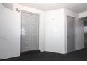 Condo hallway with a front door and a neutral color scheme, with carpeting at 1221 S Pine Ridge Cir # A2, Sanford, FL 32773