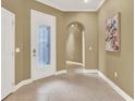 Bright foyer featuring tile floors and decorative glass front door at 1375 Brayford Point, Deland, FL 32724