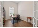 Home office with modern desk, wood floors, natural light, and built-in shelving at 15318 Sandfield Loop, Winter Garden, FL 34787