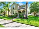 Inviting two-story home with a well-manicured lawn and a cozy front porch at 15613 Camp Dubois Cres, Winter Garden, FL 34787