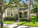 Attractive two-story home with a welcoming front porch and lush landscaping at 15613 Camp Dubois Cres, Winter Garden, FL 34787