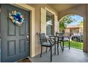 Cozy front porch with seating, a decorative wreath, and a view of the neighborhood at 15613 Camp Dubois Cres, Winter Garden, FL 34787