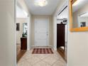 Inviting foyer with tiled floors, a white front door, and views of the interior at 1921 Geronimo Trl, Maitland, FL 32751
