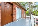 Exterior view of a unit showcasing a front door, balcony, and brickwork at 2520 Caper Ln # 206, Maitland, FL 32751