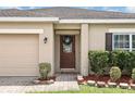 Inviting entryway with stylish front door, manicured landscaping, and brick-paved walkway at 267 Williamson Dr, Davenport, FL 33897