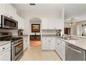Bright kitchen with white cabinets, stainless steel appliances, and neutral countertops, offering a clean design at 2696 Clearview St, Clermont, FL 34711