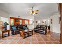 Spacious living room with tile floors, leather sofas, and a view into the dining area and kitchen at 2696 Clearview St, Clermont, FL 34711