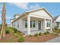 Stylish home showcasing a covered porch, modern design, and fresh landscaping, perfect for welcoming guests and enjoying outdoor living at 2926 Sailhouse Drive, St Cloud, FL 34771