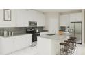 Modern kitchen with white cabinets, stainless steel appliances and a large island at 3005 Namaste Dr, Clermont, FL 34714
