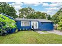 Charming blue single-story home with a well-maintained lawn and fresh landscaping at 3007 Knollwood Cir, Orlando, FL 32804