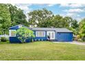Charming blue single-story home with a well-maintained lawn and fresh landscaping at 3007 Knollwood Cir, Orlando, FL 32804