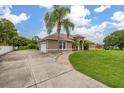 Spacious single-story home with lush lawn, long driveway, and attached two-car garage at 3779 N Econlockhatchee Trl, Orlando, FL 32817