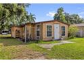 Tan home with a white door and matching window trim, with a partially fenced in yard at 4133 Cepeda St, Orlando, FL 32811