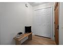 Clean and inviting entryway with storage closet and wood accent bench at 501 Benedict Ct, Casselberry, FL 32707