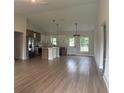 Open-concept kitchen with two-tone cabinetry, stainless steel appliances, and stylish pendant lighting fixtures at 524 Marion Oaks Blvd, Ocala, FL 34473