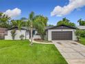 Charming single-Gathering home featuring a well-maintained lawn, brick accents and attached two car garage at 8676 Hillside Dr, Orlando, FL 32810