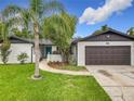 Charming single-Gathering home featuring a well-maintained lawn, brick accents and attached two car garage at 8676 Hillside Dr, Orlando, FL 32810