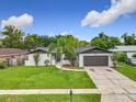 Charming single-Gathering home featuring a well-maintained lawn, brick accents and attached two car garage at 8676 Hillside Dr, Orlando, FL 32810