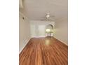 Bright living room boasts hardwood floors, a ceiling fan, and a built-in desk, creating a functional and inviting space at 911 N Orange Ave # 440, Orlando, FL 32801