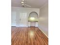 Well-lit living room featuring stylish hardwood floors, a ceiling fan, and a built-in desk perfect for working from home at 911 N Orange Ave # 440, Orlando, FL 32801