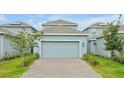 Attached two-car garage with a paved driveway, offering convenient parking and extra storage space at 11288 Listening Dr, Orlando, FL 32832