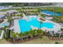Aerial view of community pool with lounge area, tennis court and splash pad for relaxation and recreation at 11288 Listening Dr, Orlando, FL 32832