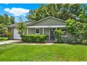 Charming one-story home with lush green lawn and a white garage door at 1210 Quintuplet Dr, Casselberry, FL 32707
