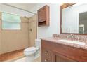 Bathroom featuring tiled shower, granite countertop and wood vanity at 123 Edgewater Cir, Sanford, FL 32773