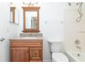 Well-lit bathroom features granite countertop, wood vanity, and tub at 123 Edgewater Cir, Sanford, FL 32773