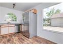 Bright kitchen featuring modern stainless steel appliances and a large window with a scenic view at 123 Edgewater Cir, Sanford, FL 32773