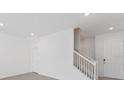 Open entryway features a staircase with white railing and carpeted steps at 1267 Stockwell Ave, St Cloud, FL 34771